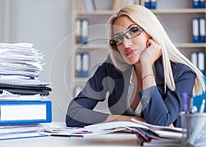 Busy businesswoman working in office at desk