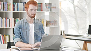 Busy Casual Redhead Man Working On Laptop