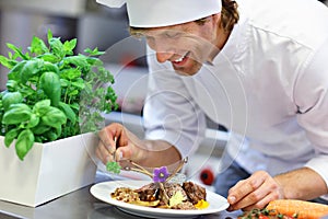 Busy chef at work in the restaurant kitchen