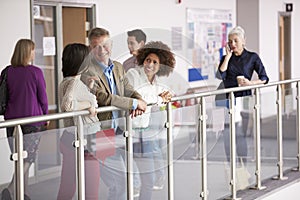 Busy College Corridor With Mature Students Talking