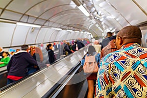 Busy commuters on elevators of an underground station in London, UK