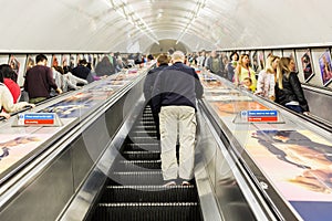 Busy commuters on elevators of an underground station in London, UK