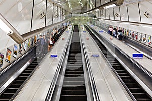 Busy commuters on elevators of an underground station in London, UK