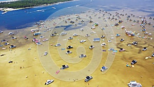 Busy Crab Island near white sandy beaches of Okaloosa Island Grass Flats in Destin, brackish water low tide and pontoons, jet skis photo