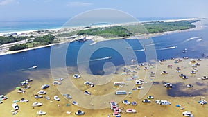 Busy Crab Island near white sandy beaches of Okaloosa Island Grass Flats in Destin, brackish water low tide and pontoons, jet skis