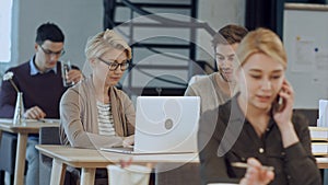 Busy design office with workers at desks