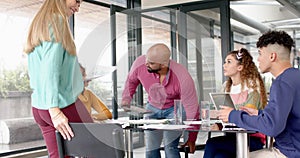 Busy diverse business people discussing work at meeting in office in slow motion