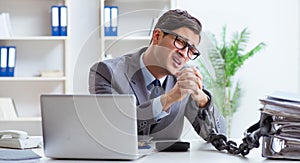 Busy employee chained to his office desk