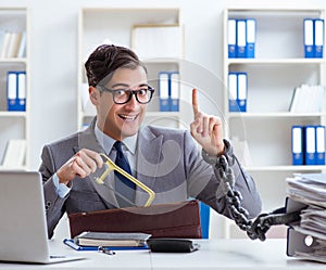 Busy employee chained to his office desk