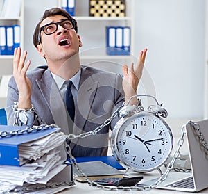 Busy employee chained to his office desk