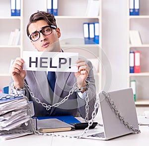 Busy employee chained to his office desk