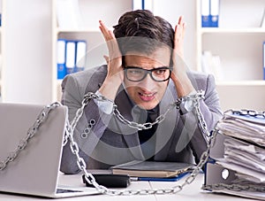 Busy employee chained to his office desk