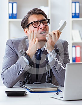 Busy employee chained to his office desk