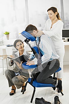Busy executive getting massage in office