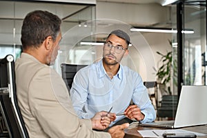 Busy executive team of two business men working in office with laptop computer.