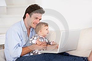 Busy father working on laptop