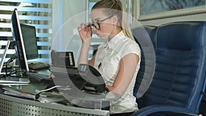 Busy female office worker using computer