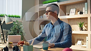 Busy freelancer sipping coffee workplace closeup. Man typing computer keyboard