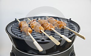 Busy with grilling a chicken sate on a bbq