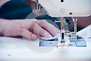 Busy hands at sewing machine.