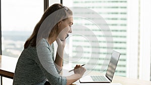 Busy happy young woman working in modern office.