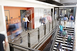 Busy High School Corridor During Recess With Blurred Students And Staff