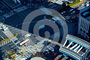 of busy intersection with traffic and people in Tokyo, Japan