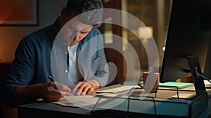 Busy man typing computer working at desk night closeup. Businessman making notes