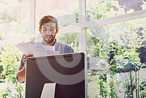 Busy man working on documents front of computer