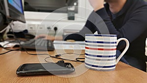 Busy man working late sitting at desk