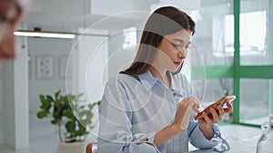 Busy manager touching mobile phone in morning closeup. Beautiful girl browsing