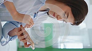 Busy manager touching mobile phone in morning closeup. Girl browsing vertically