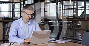 Busy mature business man lawyer ceo using laptop computer working in office.