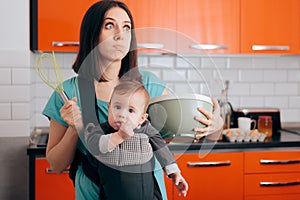 Busy Mom Cooking  Holding Baby in Carrier Babywearing System