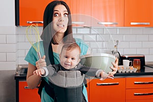 Busy Mom Cooking  Holding Baby in Carrier Babywearing System