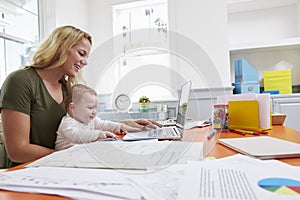 Busy Mother With Baby Running Business From Home