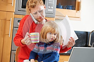 Busy Mother Coping With Stressful Day At Home photo