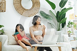 Busy mother with daughter working at home