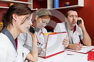 Busy nurse staff is phoning photo