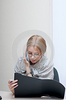 Busy office girl talking on mobile phone.