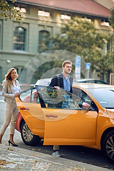 Busy people entering the cab in a hurry