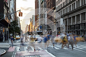Busy people walk across the crowded intersection on 23rd Street and Fifth Avenue in New York City photo