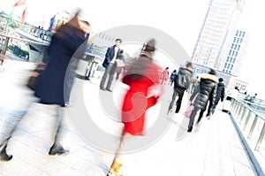 Busy people walking in a city with blurred effect