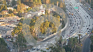 Busy rush hour intercity highway in metropolis, Los Angeles, California USA. Urban traffic jam on road in sunlight. Aerial view of