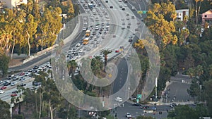 Busy rush hour intercity highway in metropolis, Los Angeles, California USA. Urban traffic jam on road in sunlight. Aerial view of