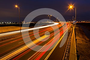 Busy rush hour traffic leaves light trails on the A9 highway