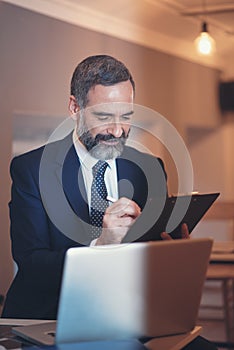 Busy senior business man in a coffee shop