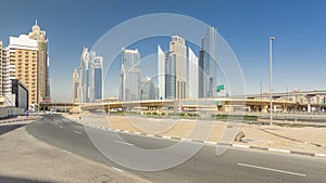 Busy Sheikh Zayed Road timelapse hyperlapse, metro railway and modern skyscrapers around in luxury Dubai city