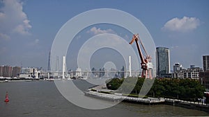 Busy shipping on river,across the sea bridge,modern urban building background.