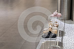 busy shoppers, shelfs in store with bags and shoes, Shelving unit with different shoes.